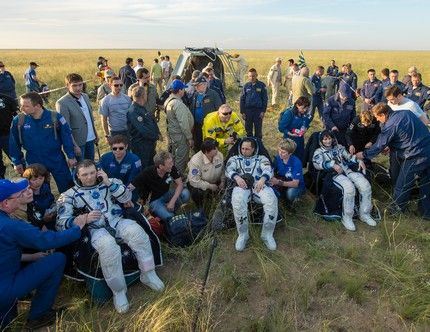 Expedition 43 commander Terry Virts of NASA, left, cosmonaut Anton Shkaplerov of the Russian Federal Space Agency (Roscosmos), center, and Italian astronaut Samantha Cristoforetti from European Space Agency (ESA) sit in chairs outside the Soyuz TMA-15M spacecraft just minutes after they landed in a remote area near the town of Zhezkazgan, Kazakhstan on Thursday, June 11, 2015. Virts, Shkaplerov, and Cristoforetti are returning after more than six months onboard the International Space Station where they served as members of the Expedition 42 and 43 crews. Photo Credit: (NASA/Bill Ingalls)